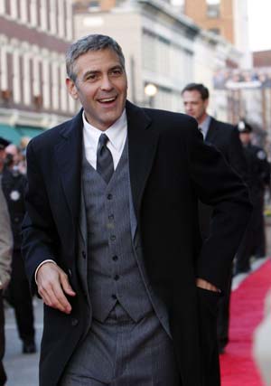 Actor George Clooney reacts to the media on the red carpet during the premiere of his new movie Leatherheads in his home town of Maysville, Kentucky March 24, 2008. 