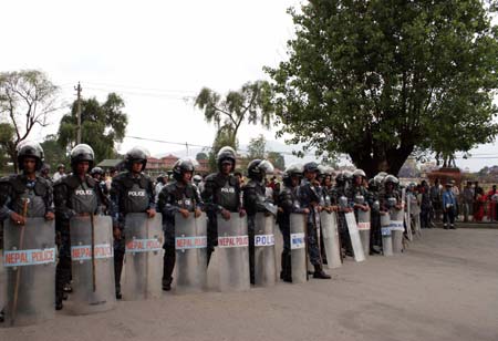 Nepali security forces stand guard in front of the Army headquarter during a protest against Nepali President Ram Baran Yadav, which was held by supporters of the Communist Party of Nepal (Maoist)(UCPN-M), in Kathmandu, capital of Nepal, May 4, 2009. Ram Baran Yadav faxed a special instruction to Rookmangud Katawal late on Sunday evening, 