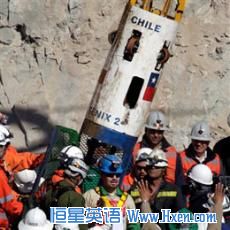 Miner Edison Pena, center, emerging from the capsule that brought him to the surface from the collapsed mine near Copiapo, Chile
